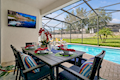 Poolside dining & TV lounge — your perfect Florida retreat.