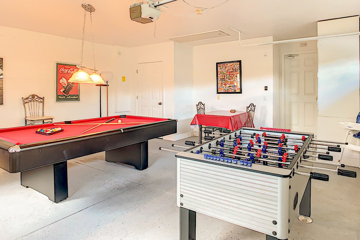 Game Room with full size slate bed pool table and foosball (table football)